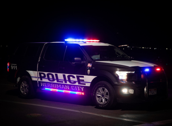Herriman City Police vehicle with emergency lights on at night